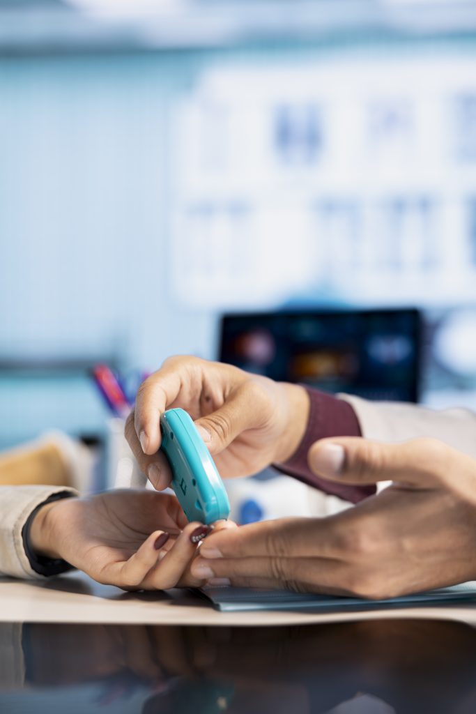 healthcare professional checking diabetic patient glucose levels